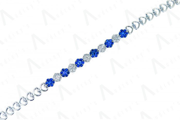 18 KARAT DIAMOND AND GEMSTONE RING
